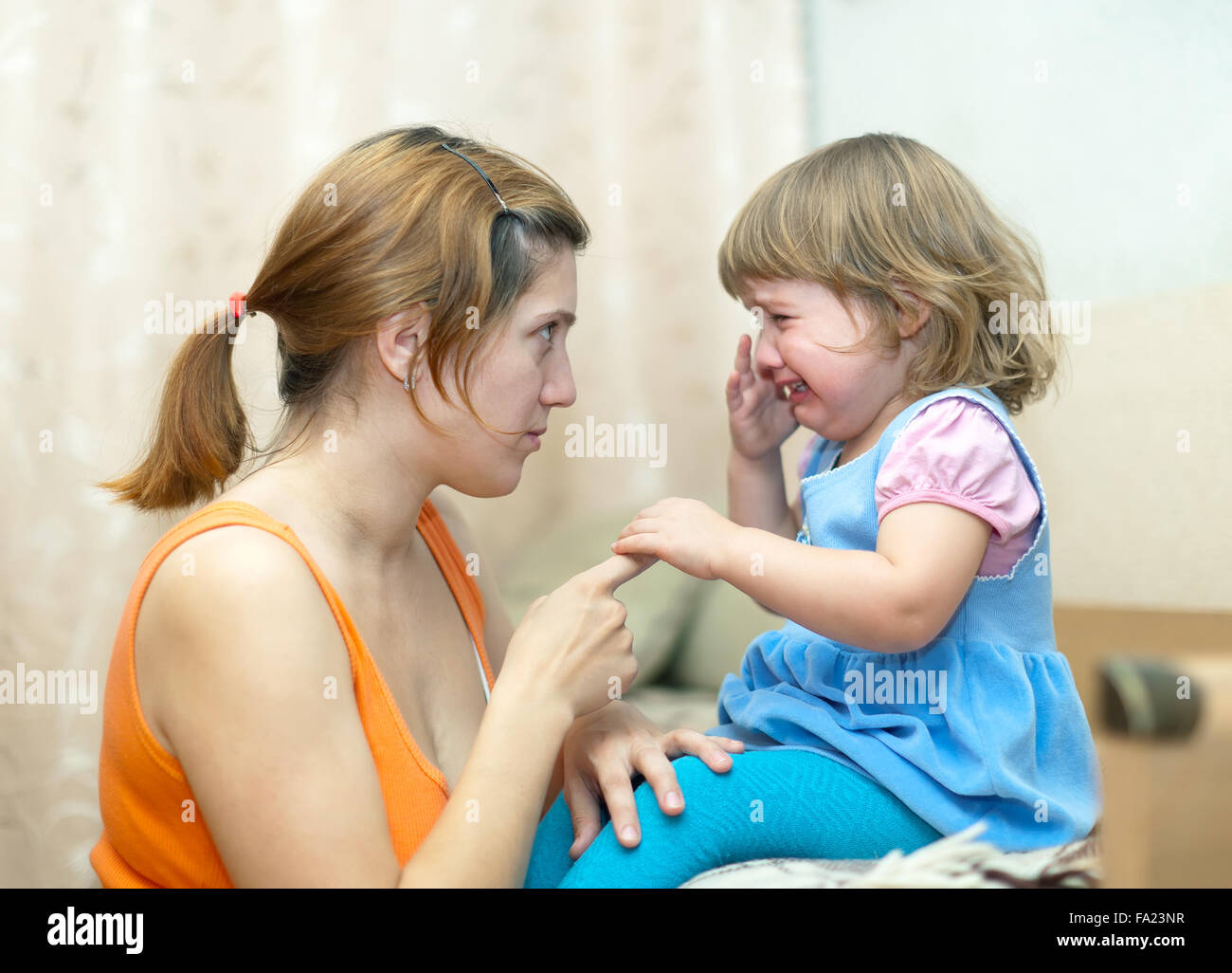 Woman berates crying baby in home Stock Photo - Alamy