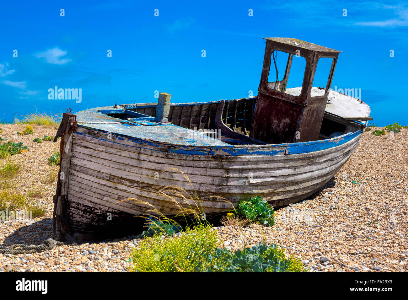 Old wooden fishing boat on a pebble beach Stock Photo - Alamy