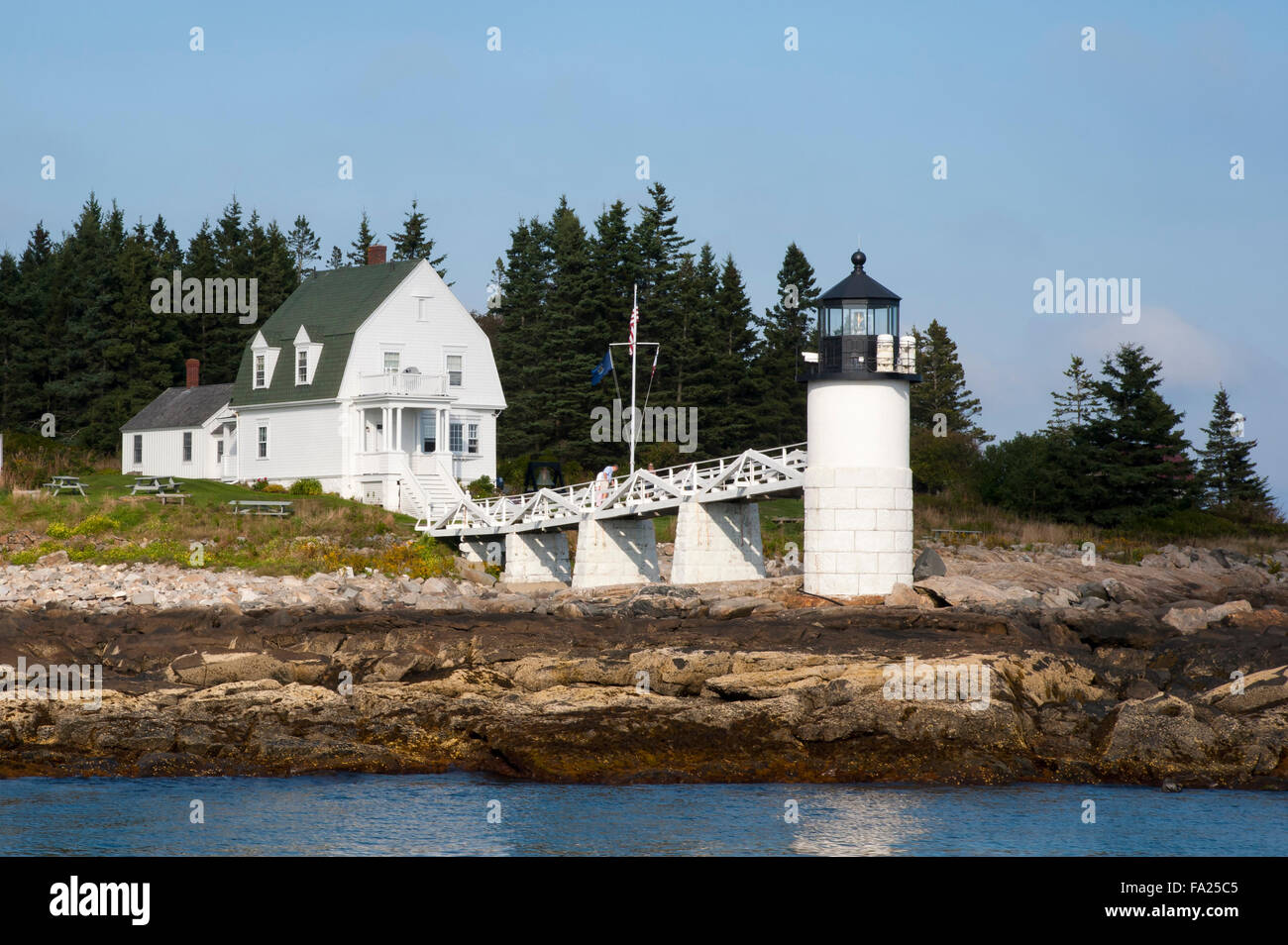 Marshall Point lighthouse on the rocky coast is a popular attraction in Port Clyde, Maine. Stock Photo