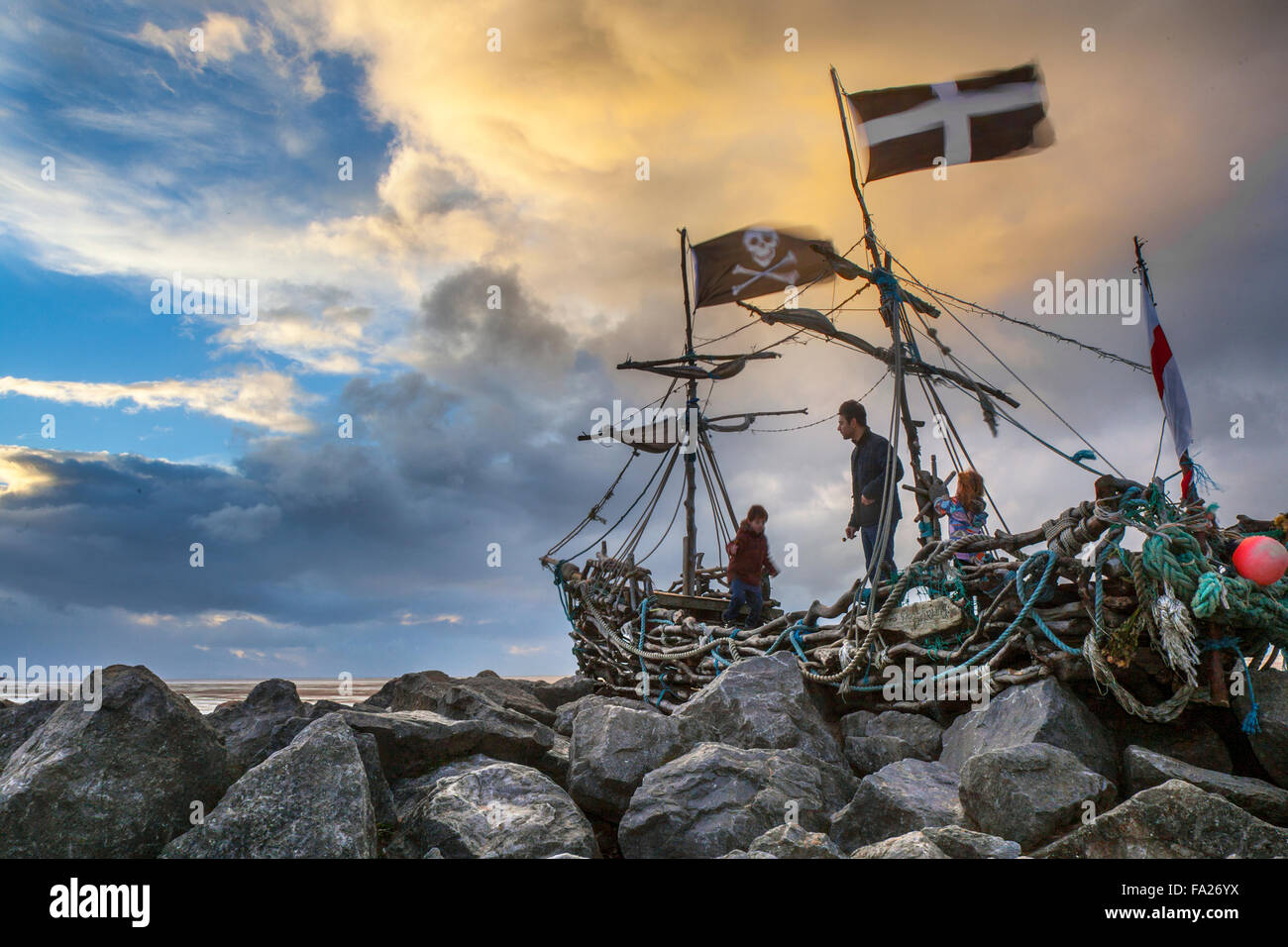 Hoylake, Wirral, 20th December, 2015. UK Weather. Storm skies over the Driftwood Boat, a children art project. The 'Grace Darling' a sculpture on Hoylake’s shore. Hoylake’s very own pirate ship named after Grace Darling who aged 22 rowed out in a storm with her father to help survivors of the SS Forfarshire, wrecked off the Farne Islands in 1838. Since she was “berthed” on the rocks by the new Hoylake Lifeboat station in Summer 2013, hundreds of children (and grown-ups) have clambered over Grace and enjoyed her close-up and from afar. Stock Photo