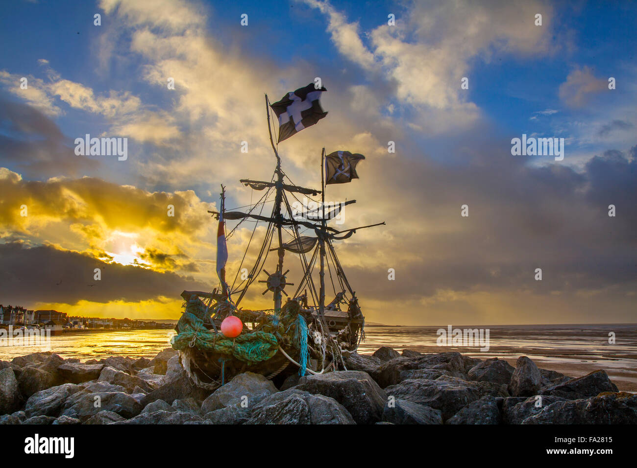 Hoylake, Wirral, 20th December, 2015. UK Weather. Storm skies over the Driftwood Boat, a children art project. The 'Grace Darling' a sculpture on Hoylake’s shore. Hoylake’s very own pirate ship named after Grace Darling who aged 22 rowed out in a storm with her father to help survivors of the SS Forfarshire, wrecked off the Farne Islands in 1838. Since she was “berthed” on the rocks by the new Hoylake Lifeboat station in Summer 2013, hundreds of children (and grown-ups) have clambered over Grace Darkling and enjoyed her close-up and from afar. Stock Photo
