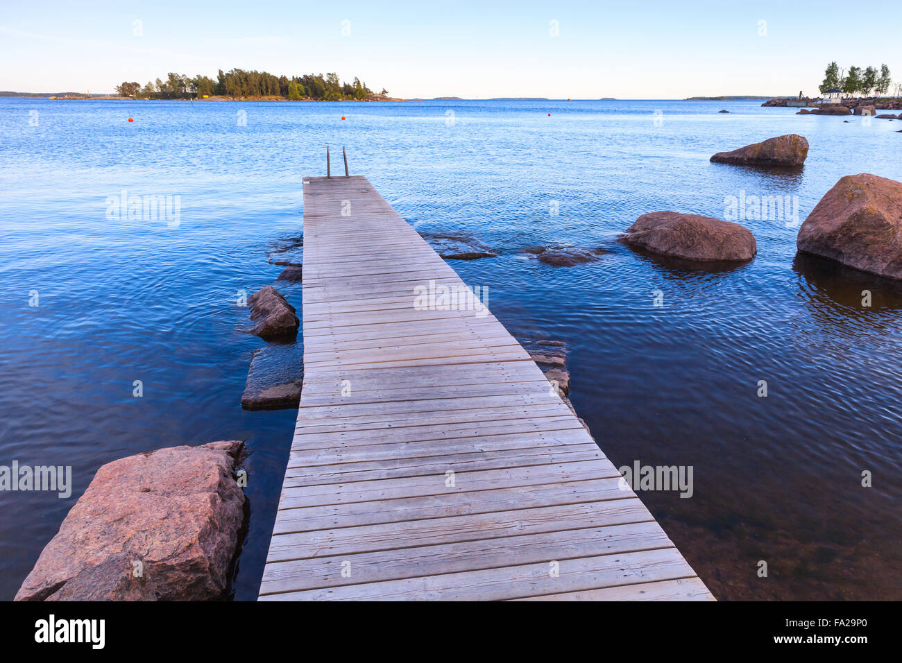 Wooden pier perspective, Saimaa lake landscape, Finland Stock Photo
