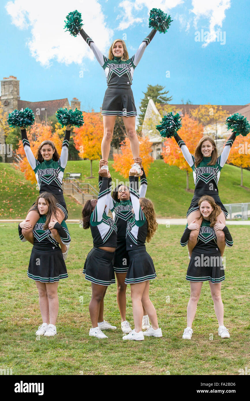 High school cheerleaders in uniform practice at their private school. Stock Photo