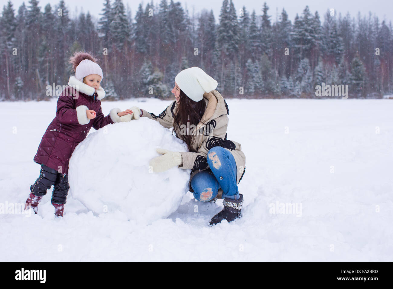 Happy family enjoy winter snowy day Stock Photo - Alamy