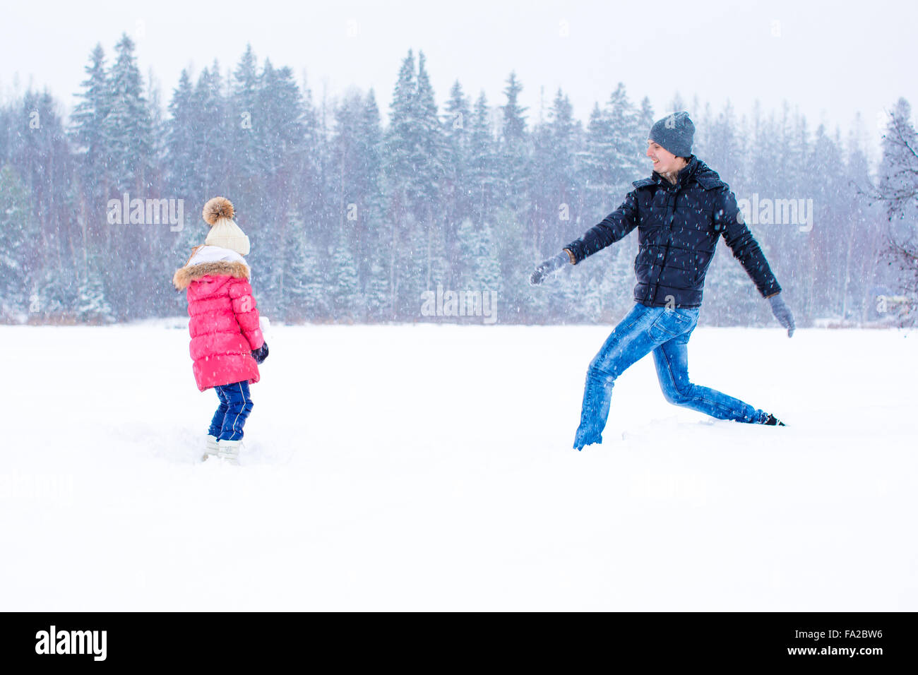 Happy family enjoy winter snowy day Stock Photo - Alamy