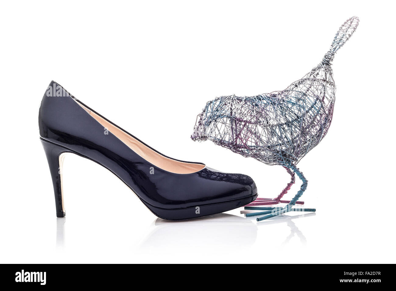 Wire Bird with High Heel shoe on a white background Stock Photo
