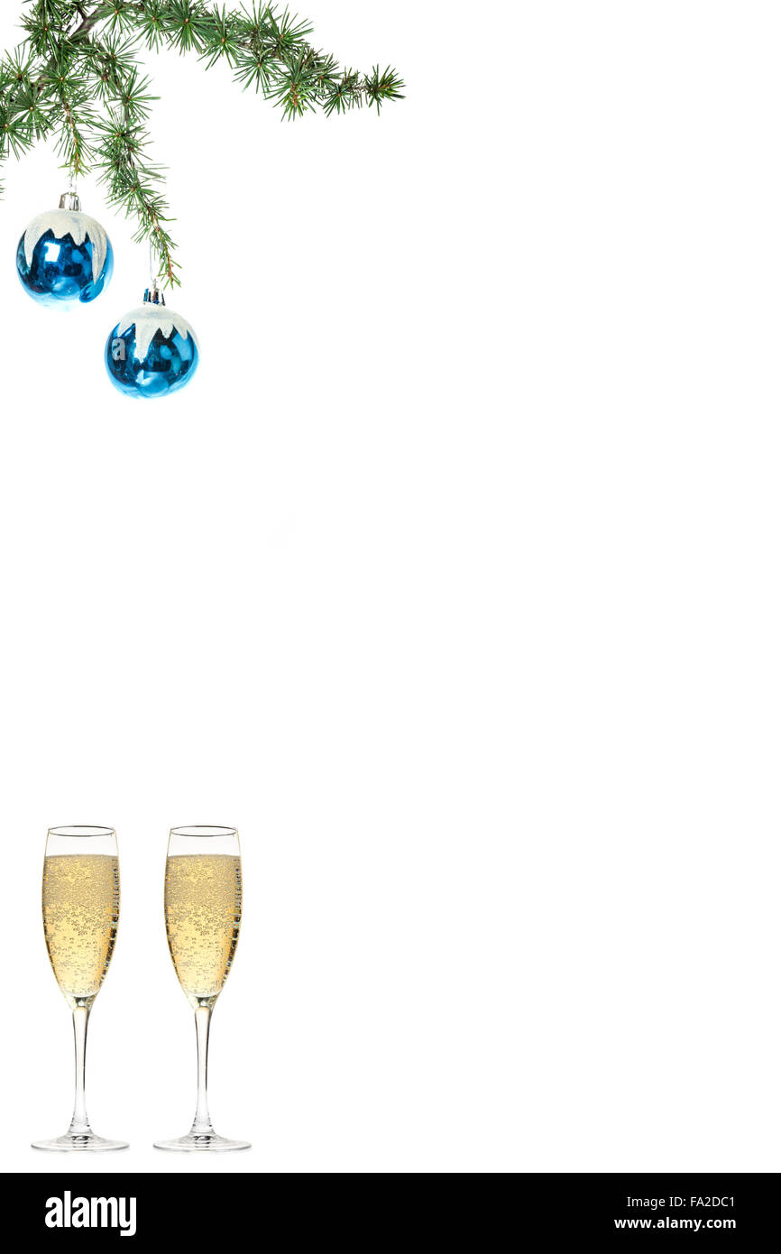 Christmas decoration with green pine or fir and blue snow roud ball ornaments for Christmas tree with two glasses of champagne.  Stock Photo
