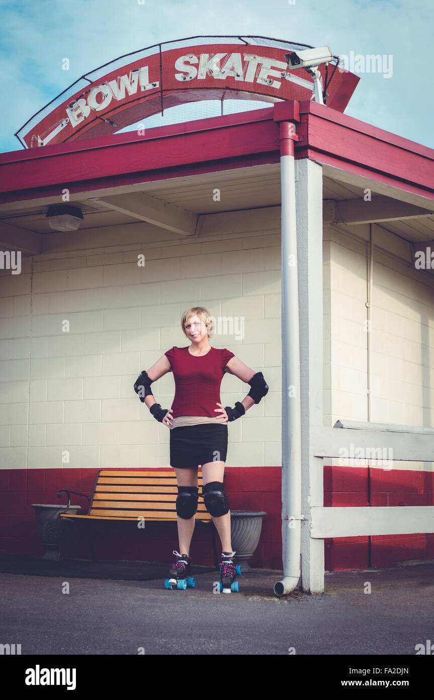 Roller derby, roller skating woman outside of roller rink with roller skates on. Stock Photo
