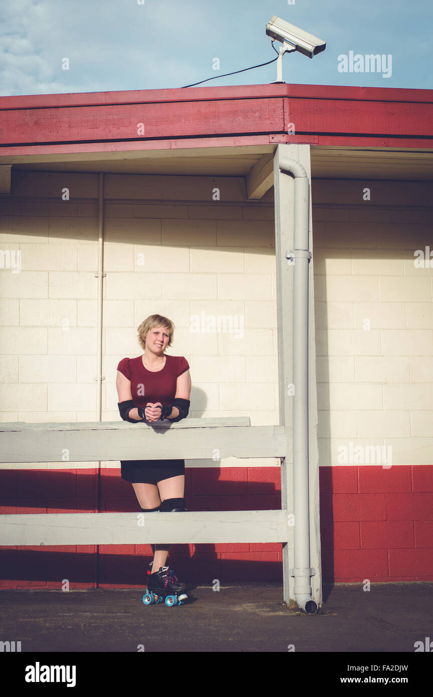 Roller derby, roller skating woman outside of roller rink with roller