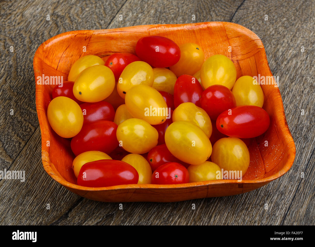 Yellow and red cherry tomatoes mix on the basket Stock Photo - Alamy