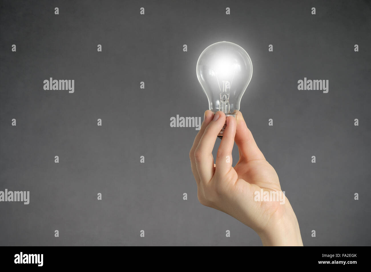 Hand holding a glowing light bulb Stock Photo - Alamy