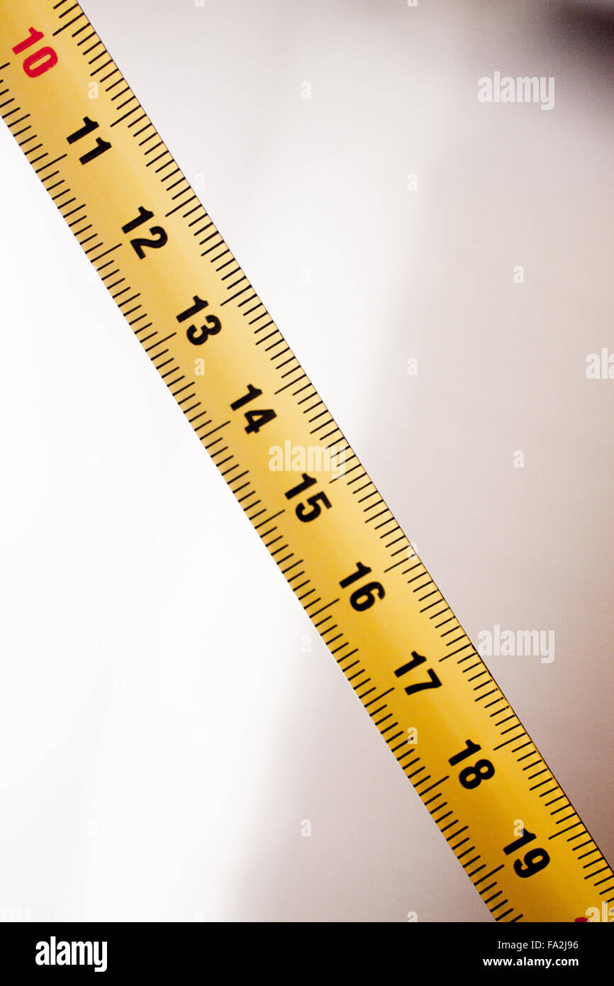 Measuring tape metal ruler showing measuement in centimeters (cm) numbers  on plain background Stock Photo - Alamy