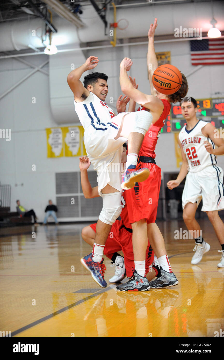 High school players collide in the lane which sends the basketball reeling off as a result of the contact. USA. Stock Photo