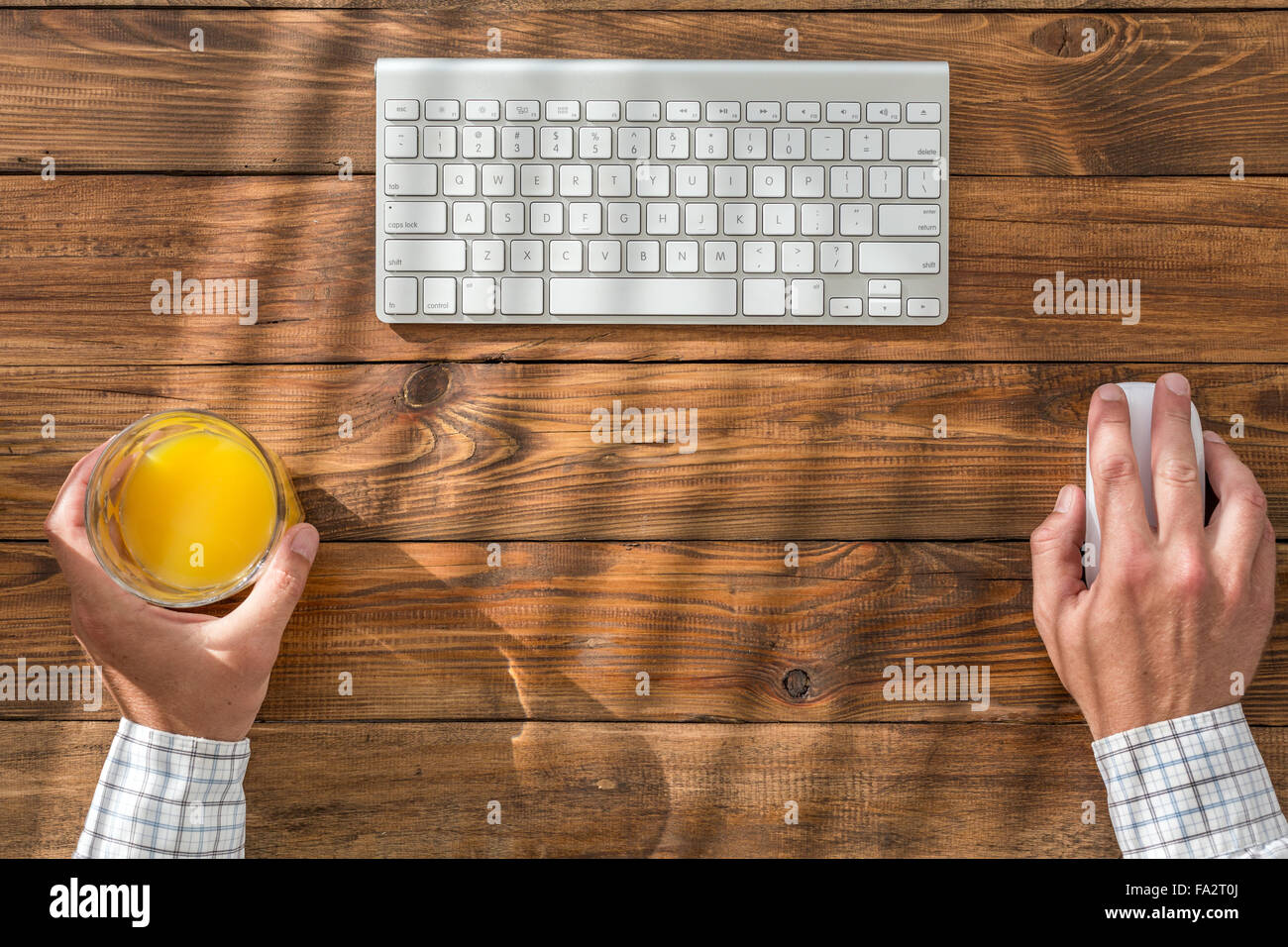 Top view of man at natural wooden desk Stock Photo