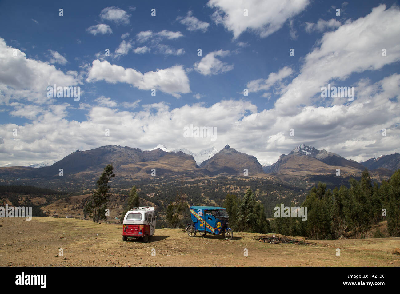 Panoramic view of Cordillera Blanca and motor rickshaws at Huaraz, Peru. Stock Photo