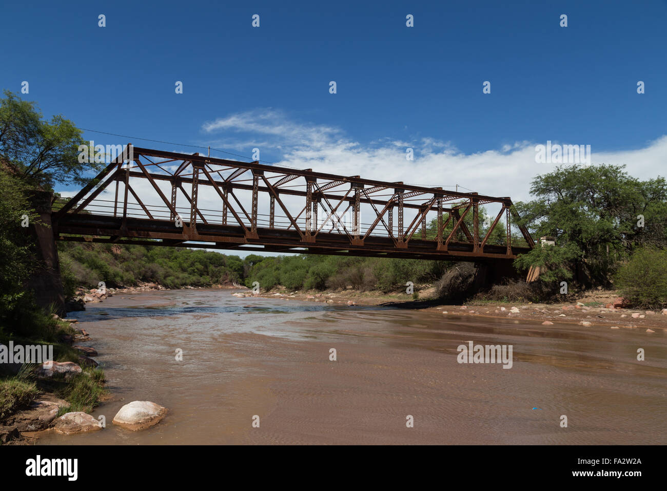 Photograph of a steel bridge construction over a river in the small village Alemania, Argentina. Stock Photo