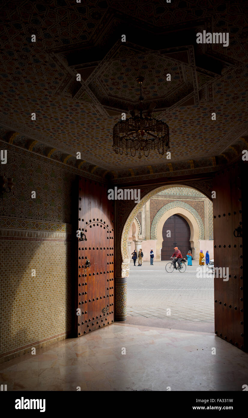 Cyclist in front of The Bab el Mansour gate, view from inside a entry hall of a classical building. Rabat, Morocco. Stock Photo