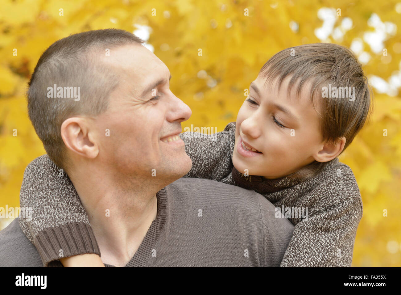Father and son in autumn park Stock Photo - Alamy