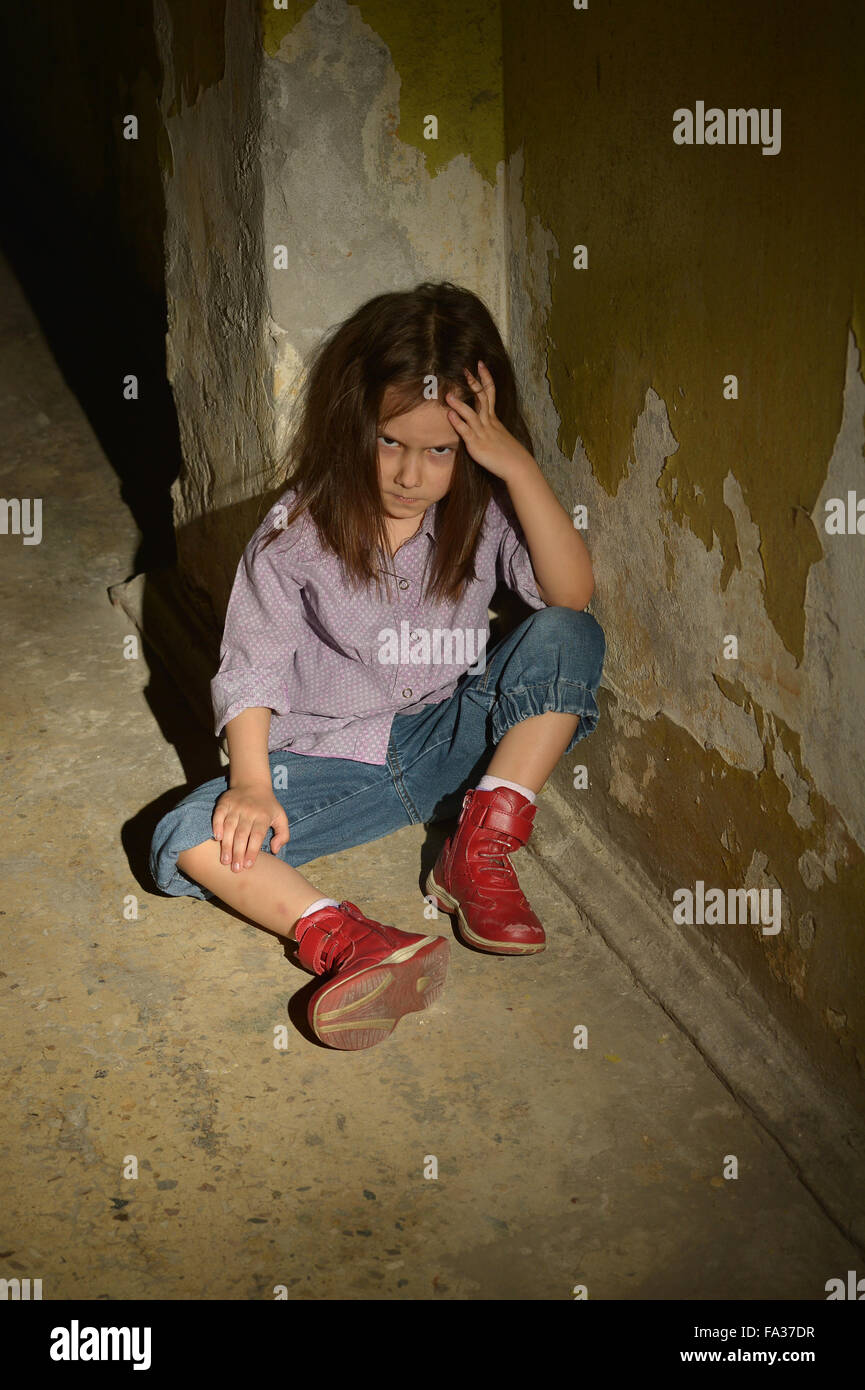 little girl in a dark cellar Stock Photo