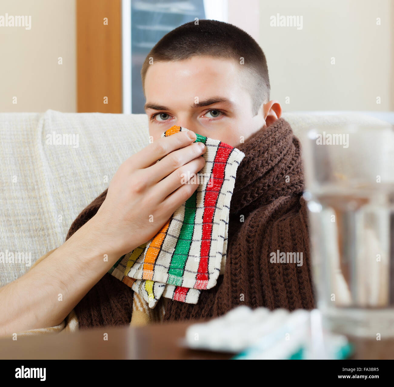 man in plaid using handkerchief in home Stock Photo Alamy