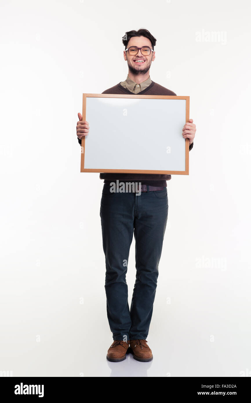 Full length portrait of a smiling man holding blank board isolated on a white background Stock Photo