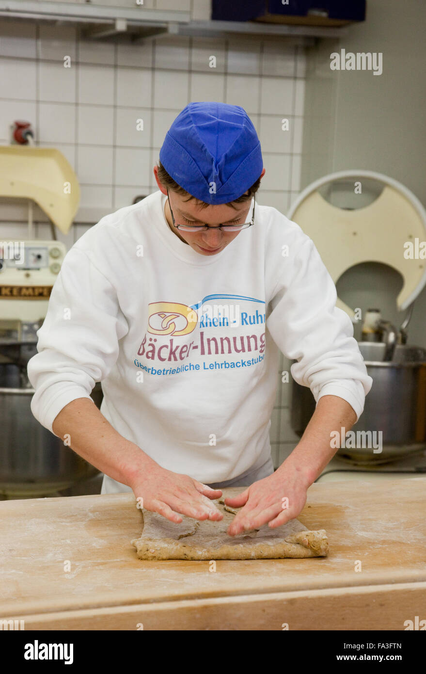 Baker apprentice kneads bread dough Stock Photo Alamy