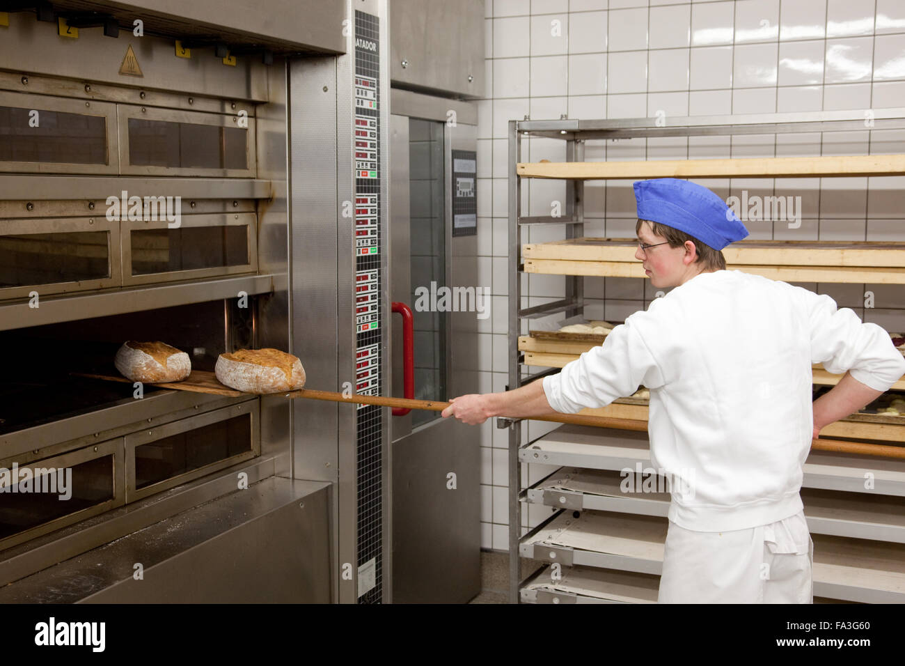 Baker apprentice baked bread Stock Photo Alamy