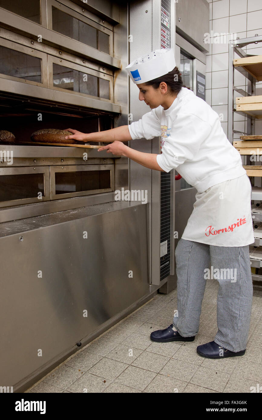 Baker apprentice baked bread Stock Photo Alamy