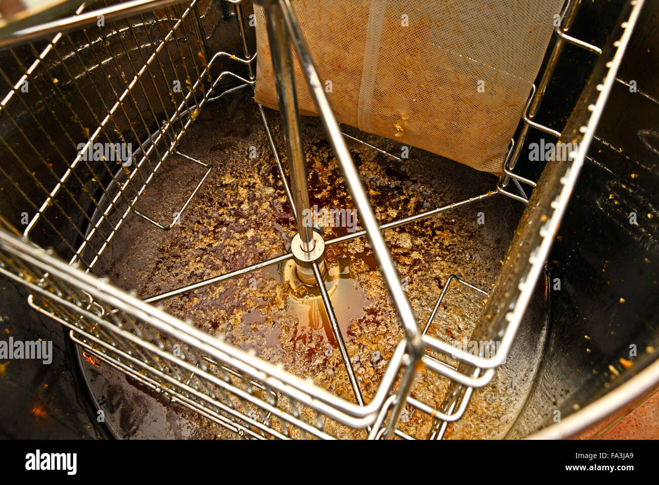 Honey in the bottom of an extractor after it has spun the honey out of the frames Stock Photo