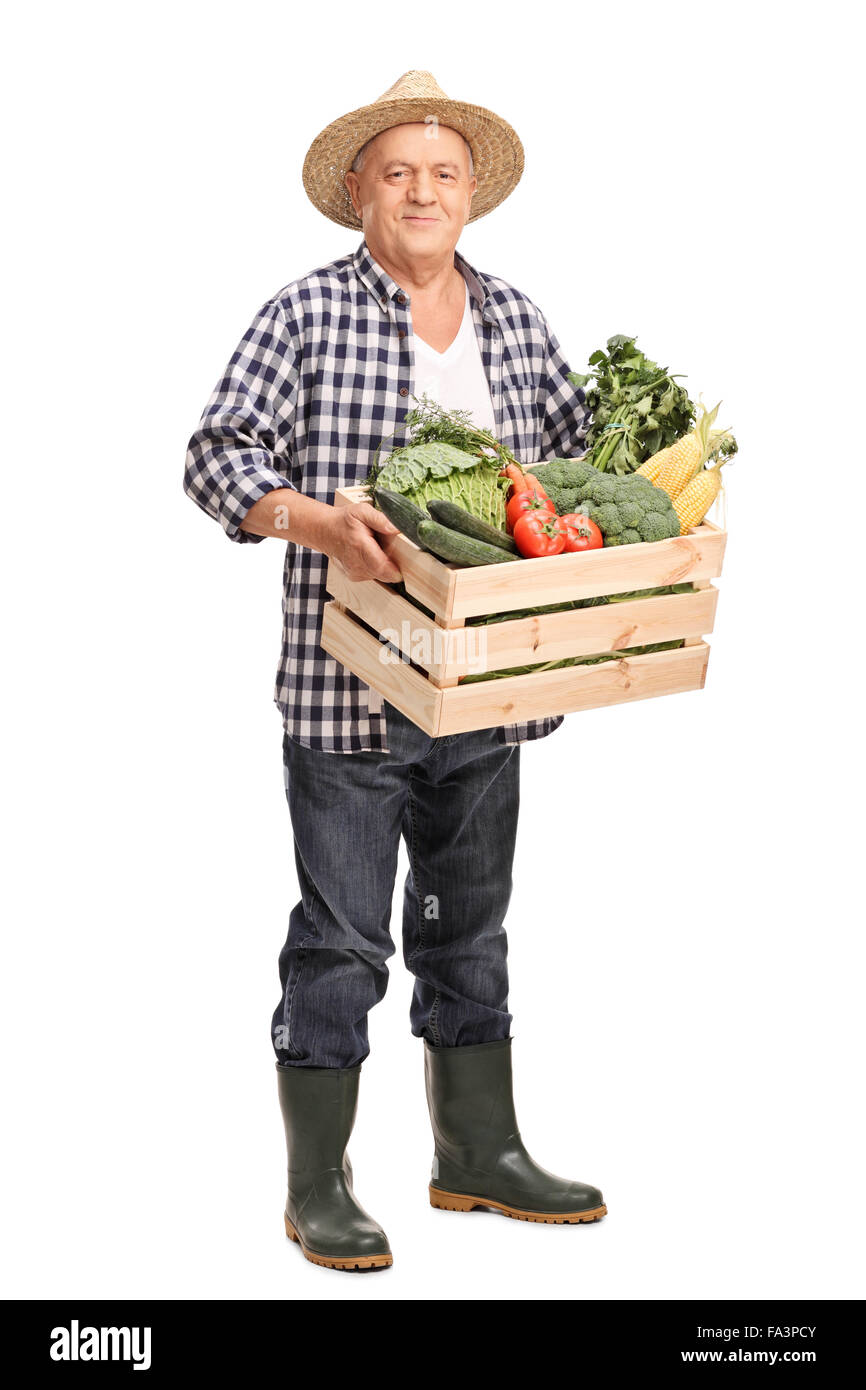 Full length portrait of a mature farmer carrying a wooden crate full of ...