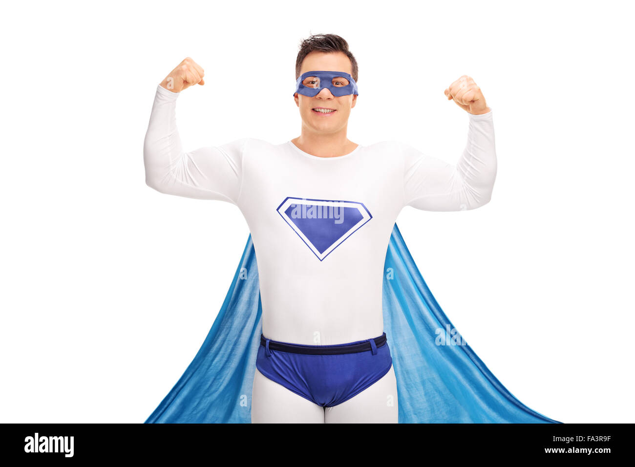 Young male superhero flexing his both hands and looking at the camera isolated on white background Stock Photo