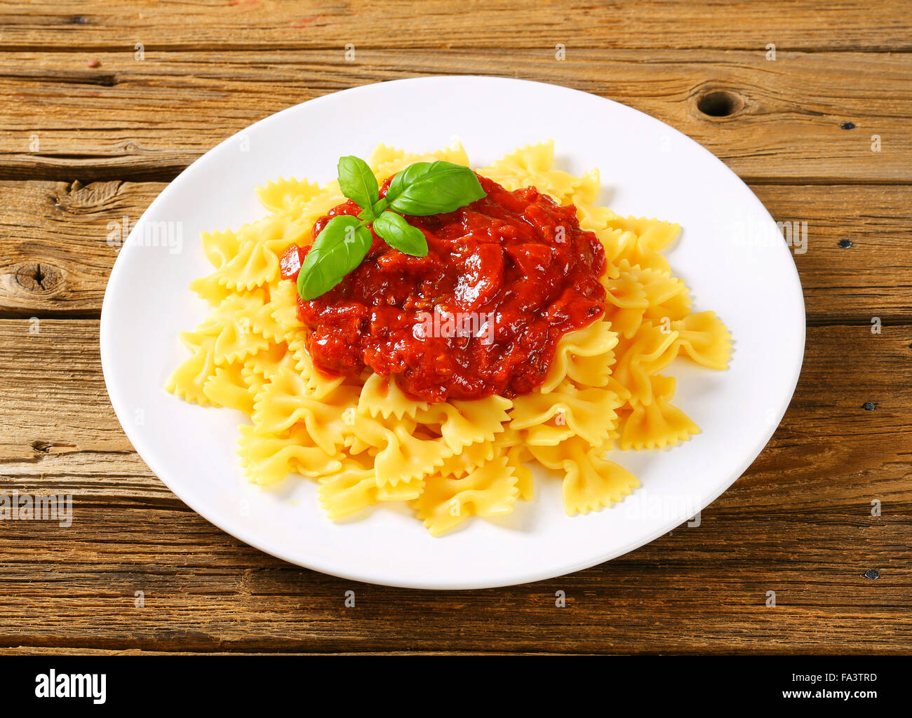 Bowtie pasta with thick tomato sauce Stock Photo Alamy