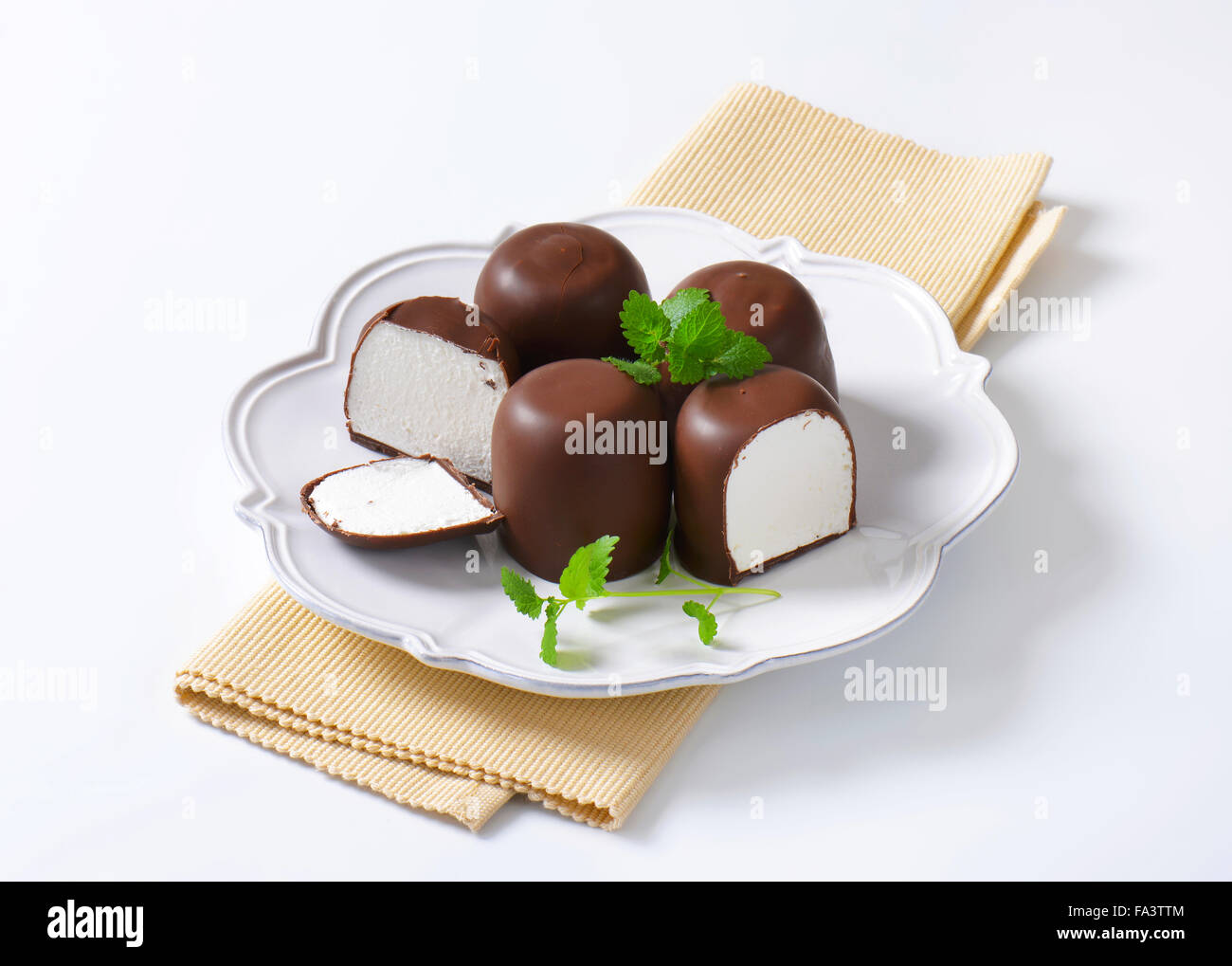Marshmallows coated in milk chocolate Stock Photo Alamy