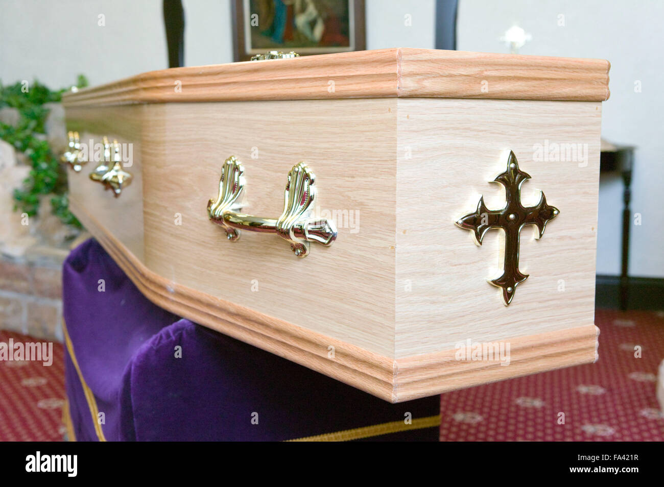 Wooden coffin lying on catafalque in a crematorium, Stock Photo