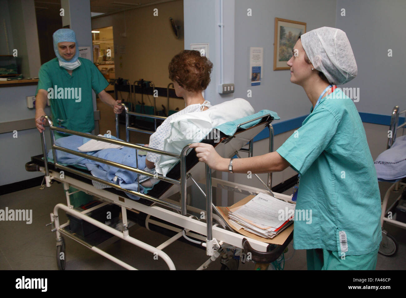 Patient being wheeled into operating theatre by Operation Department Practitioners, Stock Photo
