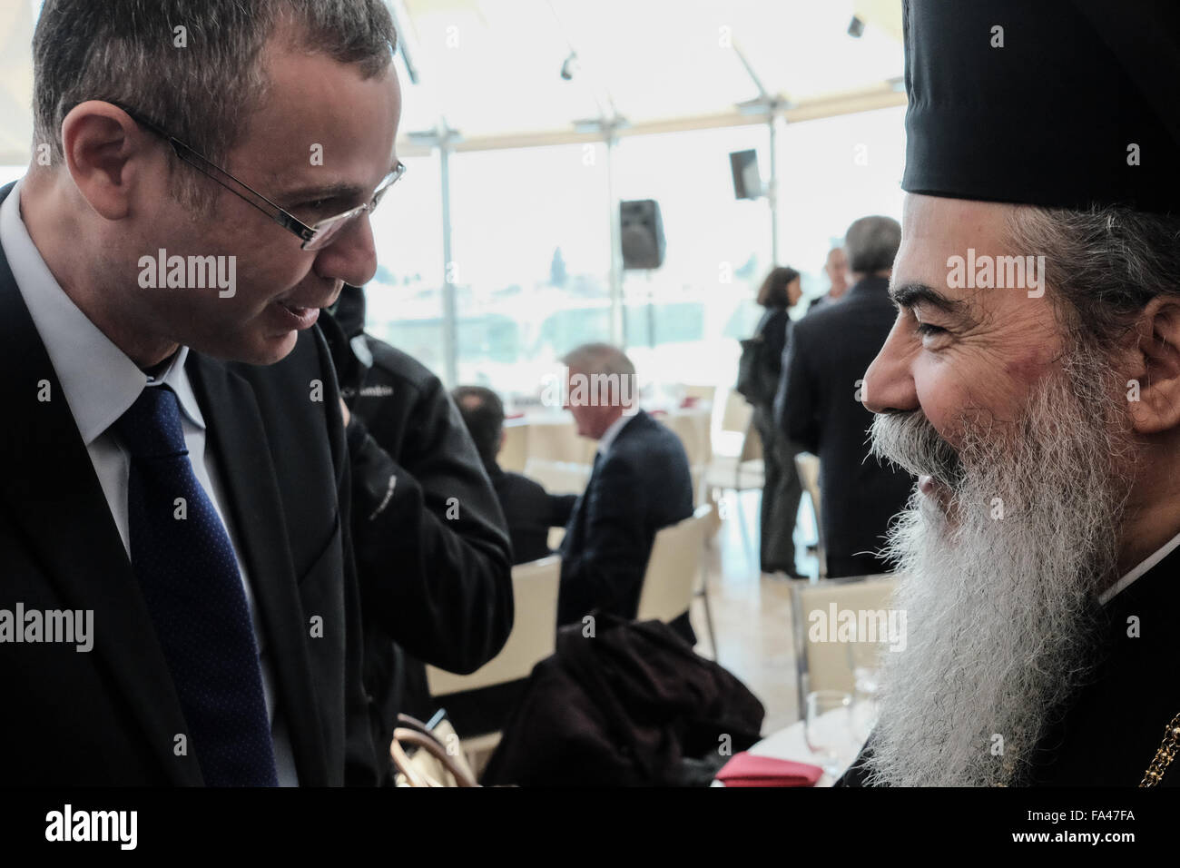 Jerusalem, Israel. 21st December, 2015. Israeli Minister of Tourism, YARIV LEVIN (L), welcomes Greek Orthodox Patriarch Of Jerusalem, THEOPHILOS III (R), at the Blaustein Hall in the Shimshon Center. Minister Levin hosted a pre-Christmas reception for leaders of the Christian communities and churches in Israel at the Shimshon Center, Beit Shmuel, in Jerusalem. Credit:  Nir Alon/Alamy Live News Stock Photo