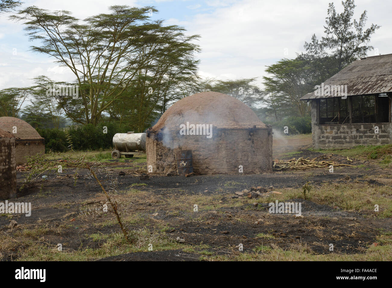 Traditional charcoal making kiln burning wood for charcoal in Kenya at