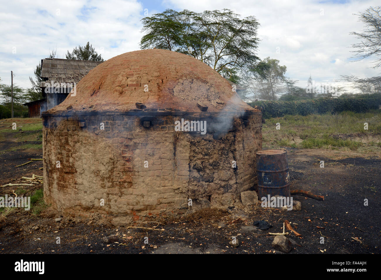 A traditional charcoal making kiln burning charcoal in Kenya at