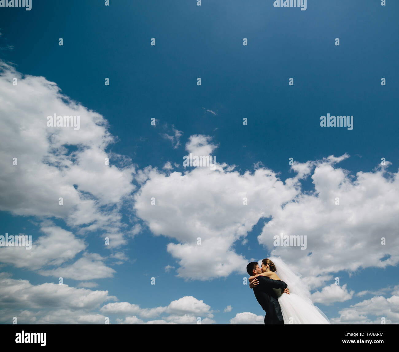 couple on blue sky background Stock Photo - Alamy