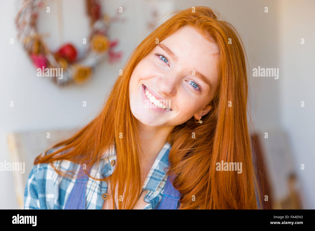 Portrait of beautiful happy young woman with long red hair looking ...