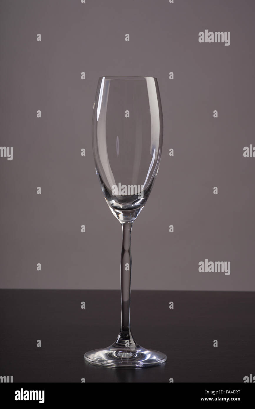 Empty Champagne glass with reflections on dark background Stock Photo