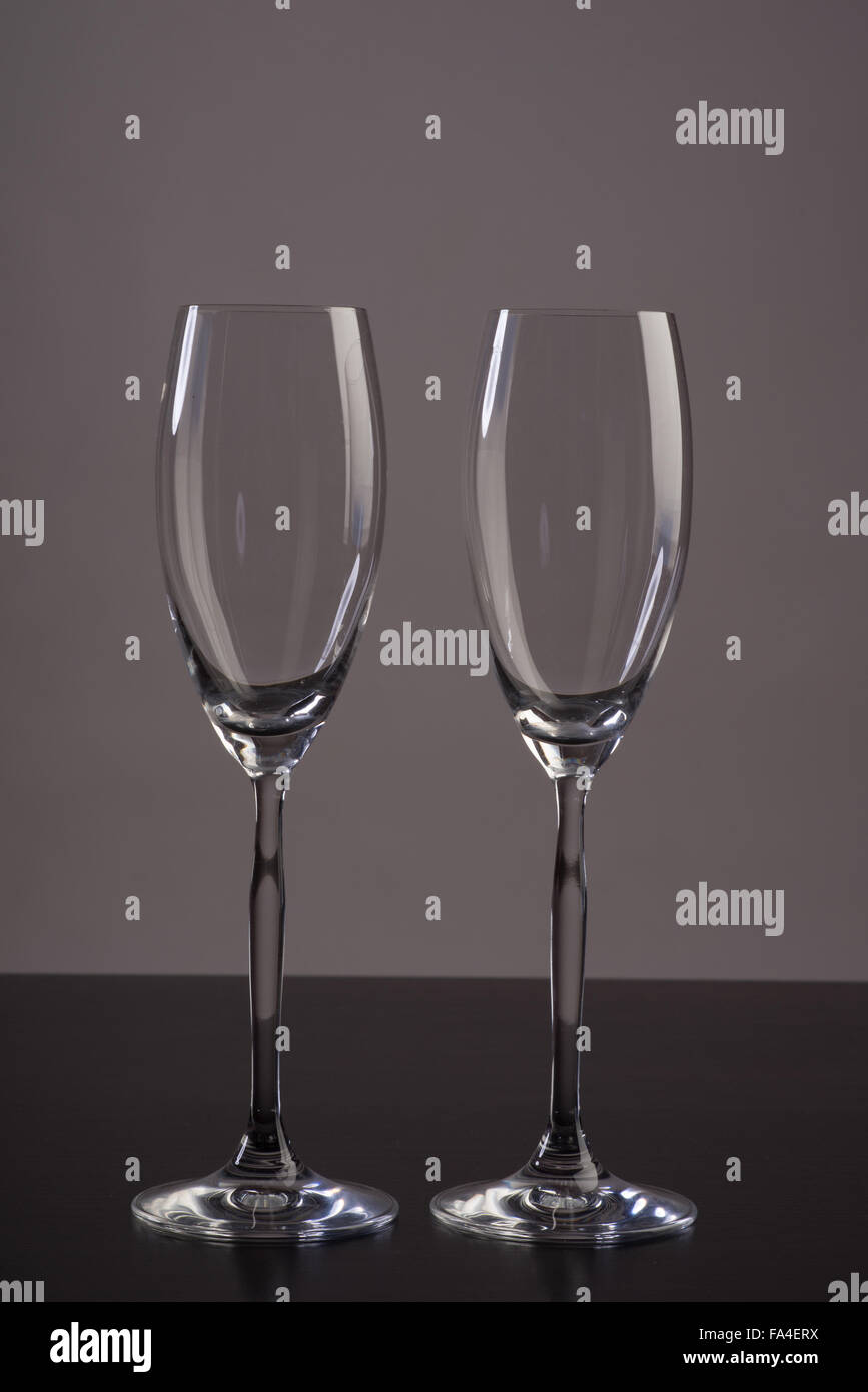 Two empty champagne glass with reflections on grey background Stock Photo