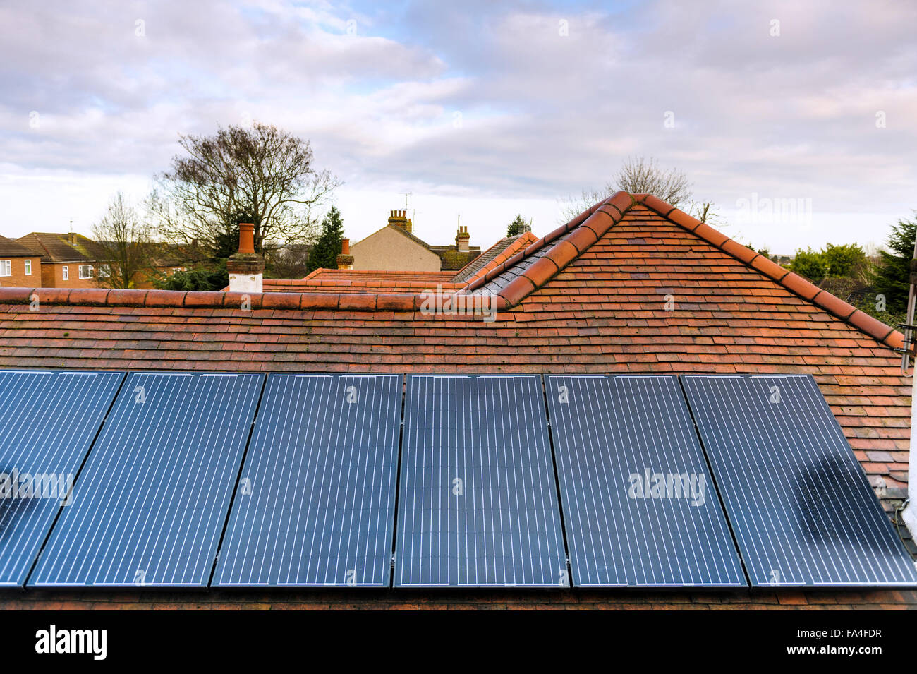 Solar roof panels on the roof of an urban bungalow. Stock Photo