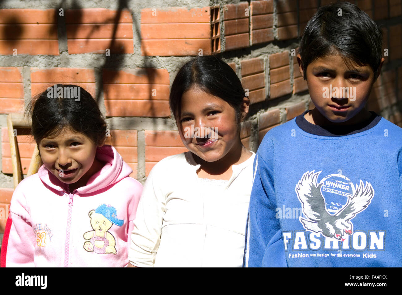 Three Bolivian children pose for the camera in Luribay, Bolivia, South America. Stock Photo