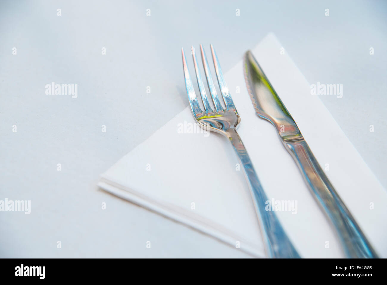 Fork and knife on set table. Close view. Stock Photo