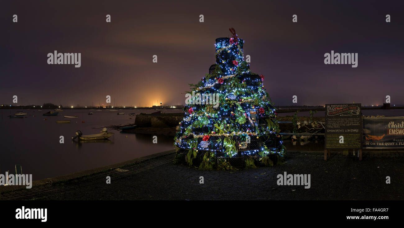 A Christmas tree constructed entirely from lobster pots glitters on the quayside in Emsworth