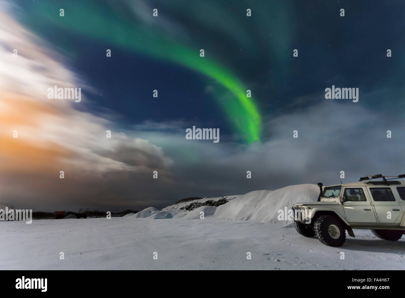Northern Lights, Aurora Borealis in snowy landscape, 4x4  Aurora chasing tour jeep parked in foreground, Thingvellir, Iceland Stock Photo