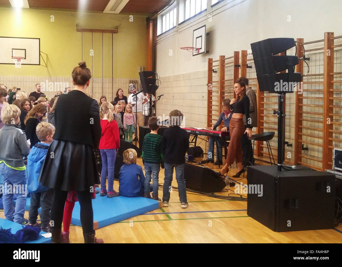 Medina talks to children at a Scandinavian school in Berlin. Afterwards she performs some songs at the school's gym.  Featuring: Medina Where: Berlin, Germany When: 20 Nov 2015 Stock Photo