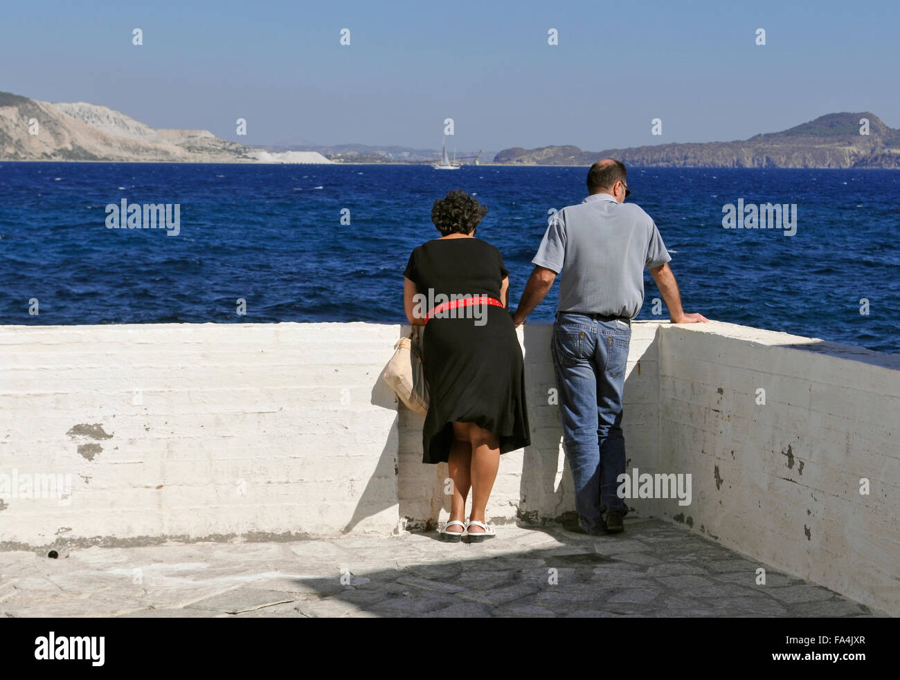 couple of tourists in Mandraki, Nissiros Island, Greece Stock Photo