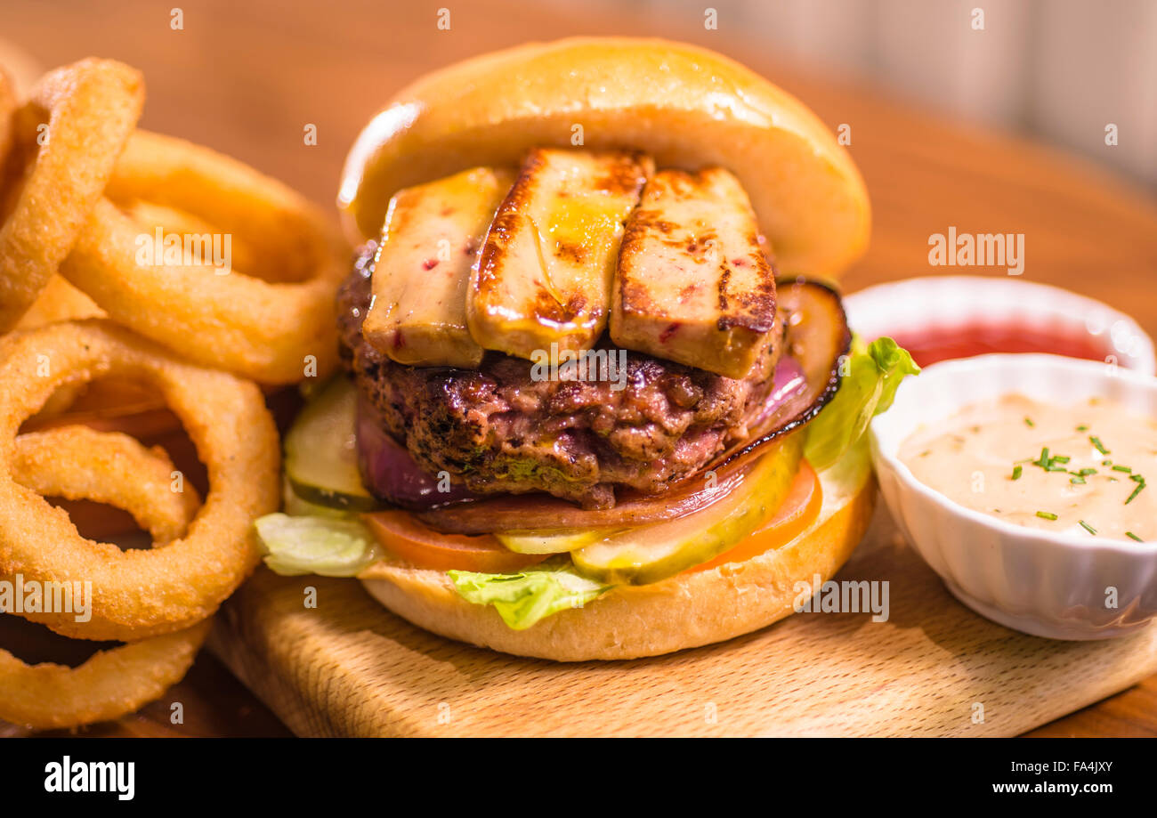 A burger is served with salad and Foie gras Stock Photo